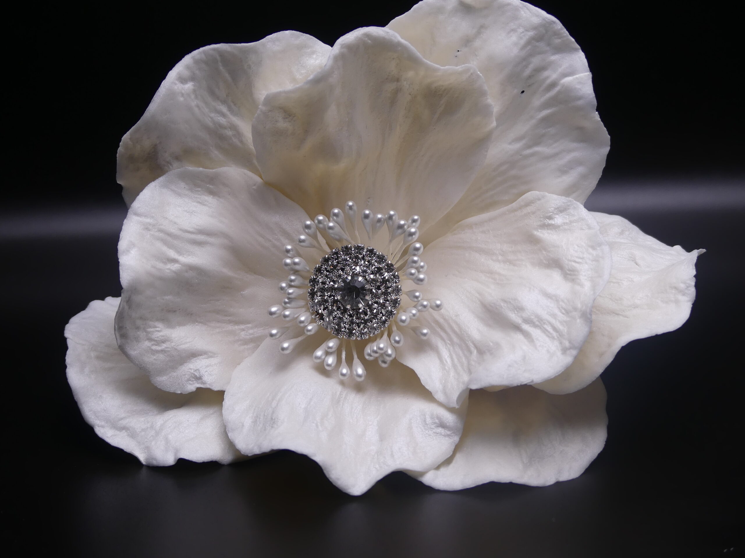 Large white flower with jeweled center
